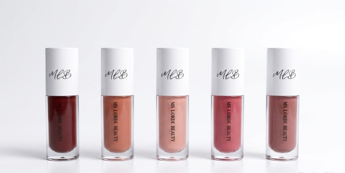 Five bottles of MBL lipstick on a white background